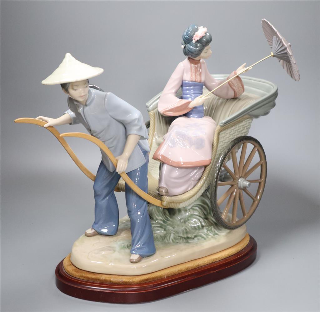 A large Lladro of a Japanese rickshaw, on plinth, height 33cm